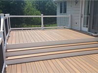 <b>Trex Composite deck with steps and vinyl railing with black aluminum ballusters</b>